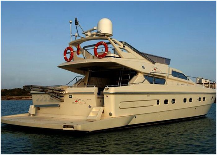 Classic 80-foot motor yacht at anchor in calm water