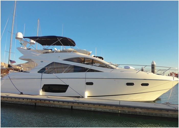 Sunseeker flybridge yacht moored stern-to at a marina