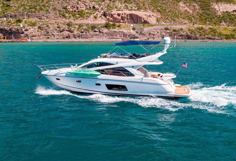 60-foot Sunseeker Manhattan flybridge yacht cruising along the coast